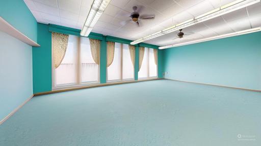 Generous room with furnishings digitally removed to highlight the generous natural light and flexible layout potential.