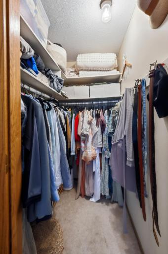 Primary bedroom closet hosts attire for all seasons