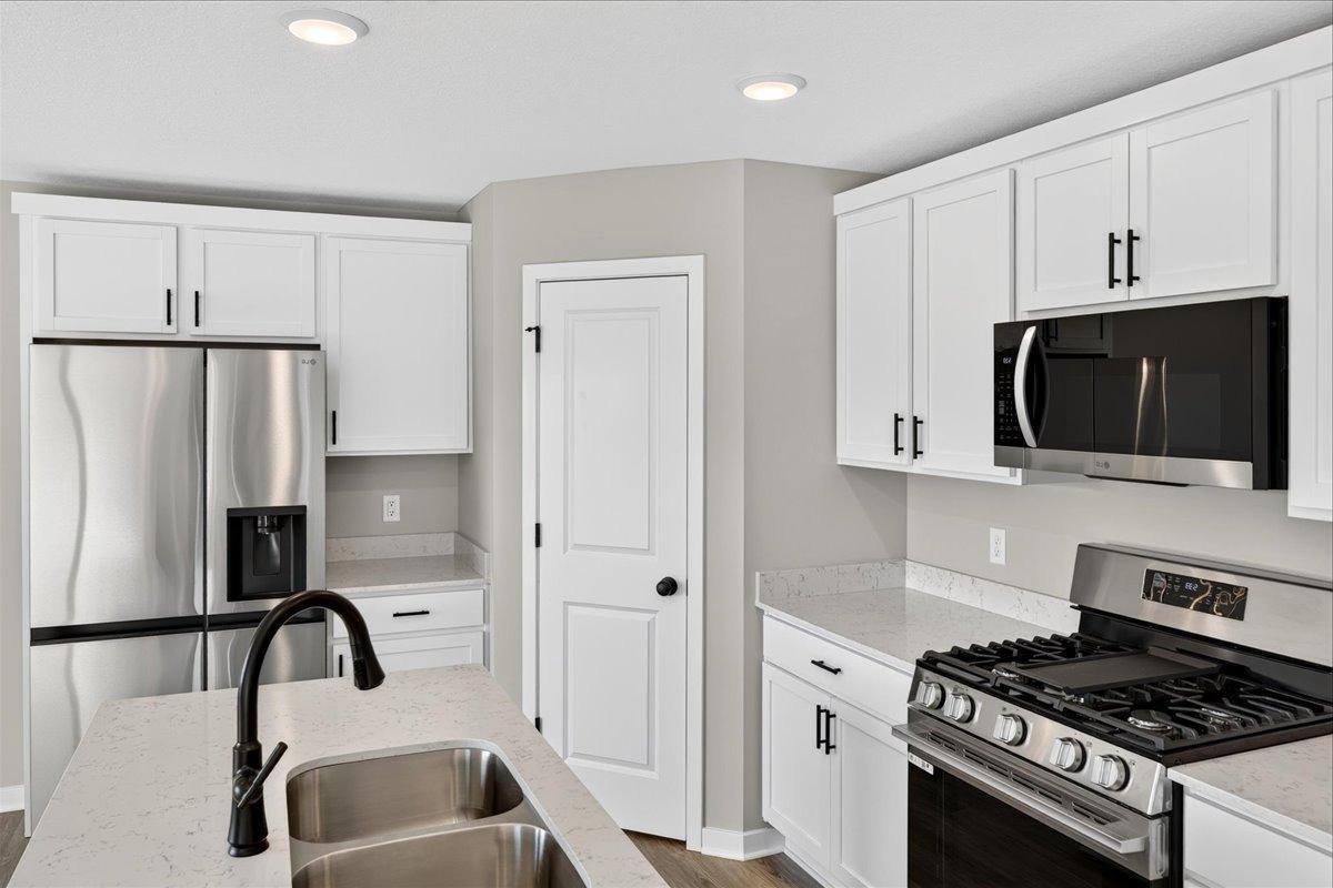 Kitchen. Photo taken of another home with similar plan and finishes.