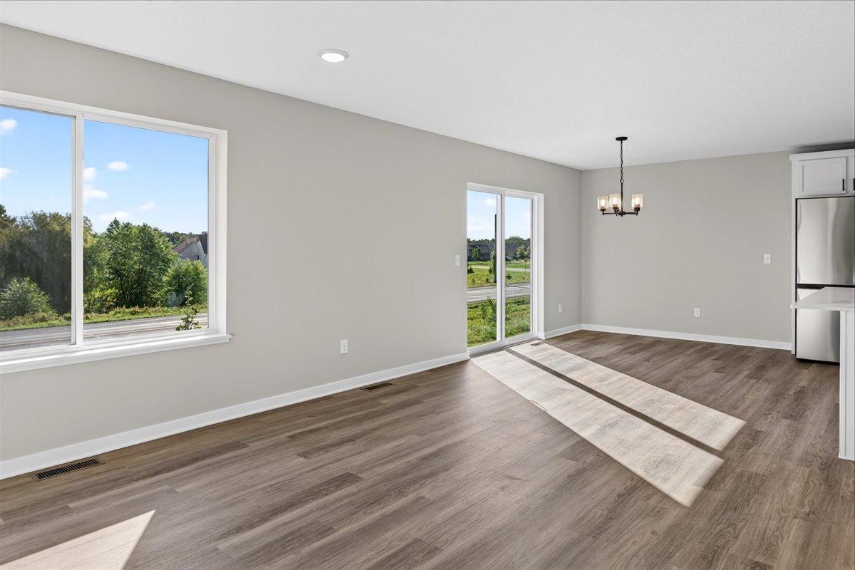 Living & Dining Room. Photo taken of another home with similar plan and finishes.