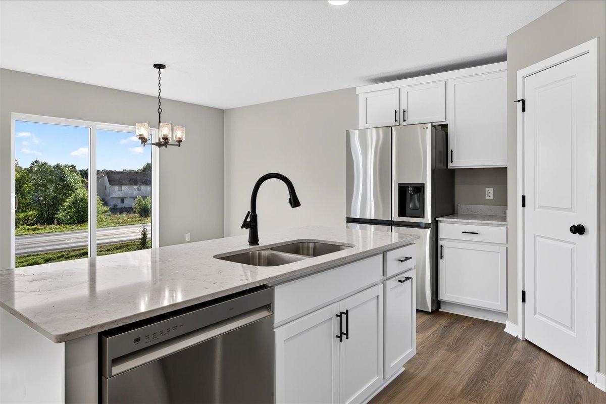 Kitchen & Dining Room. Photo taken of another home with similar plan and finishes.