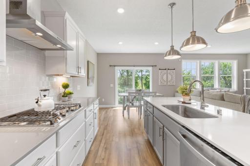 Gourmet Kitchen w/ quartz counters, oversized island, SS apps (inc gas cooktop) & walk-in pantry