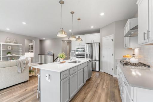 Gourmet Kitchen w/ quartz counters, oversized island, SS apps (inc gas cooktop) & walk-in pantry