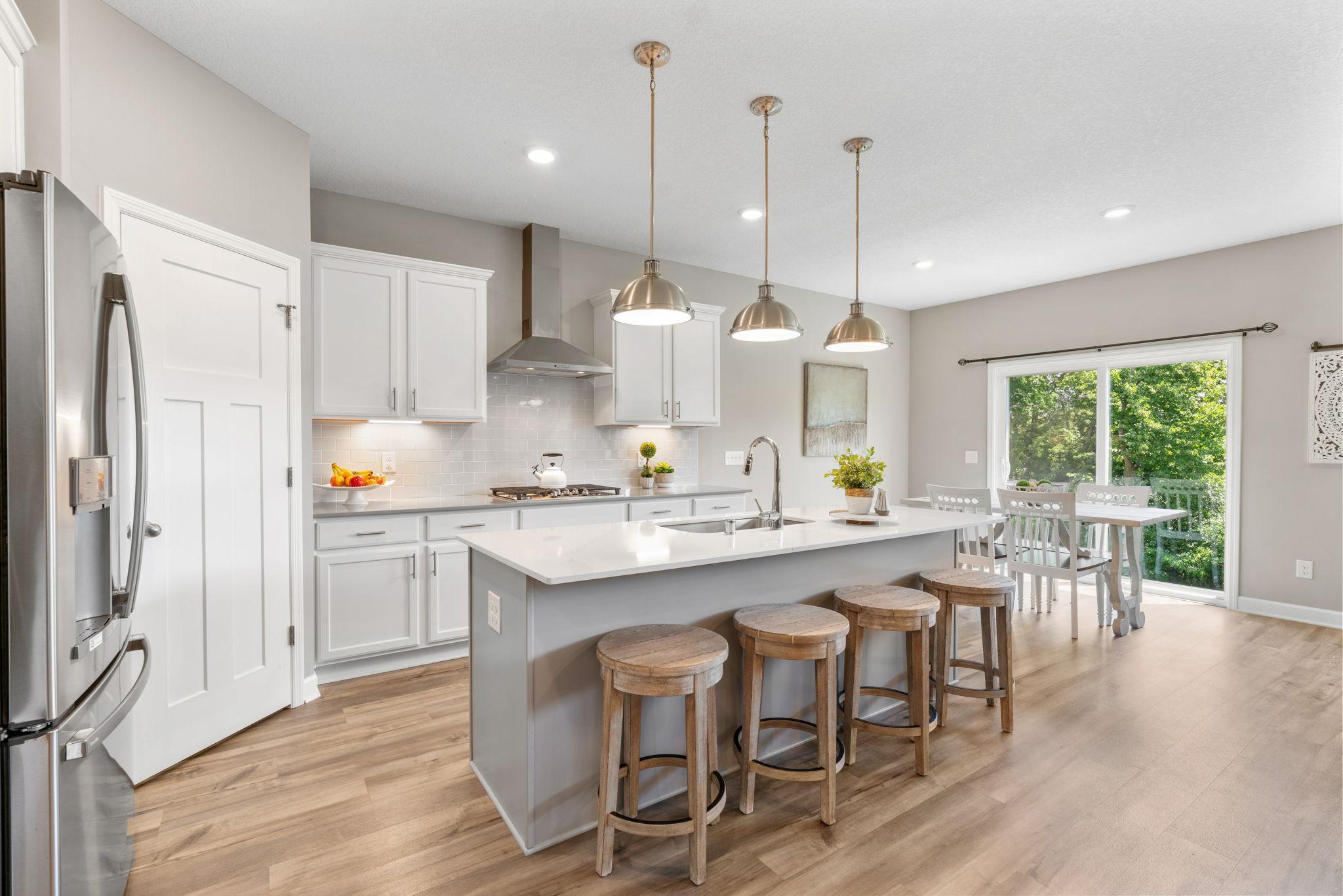 Gourmet Kitchen w/ quartz counters, oversized island, SS apps (inc gas cooktop) & walk-in pantry