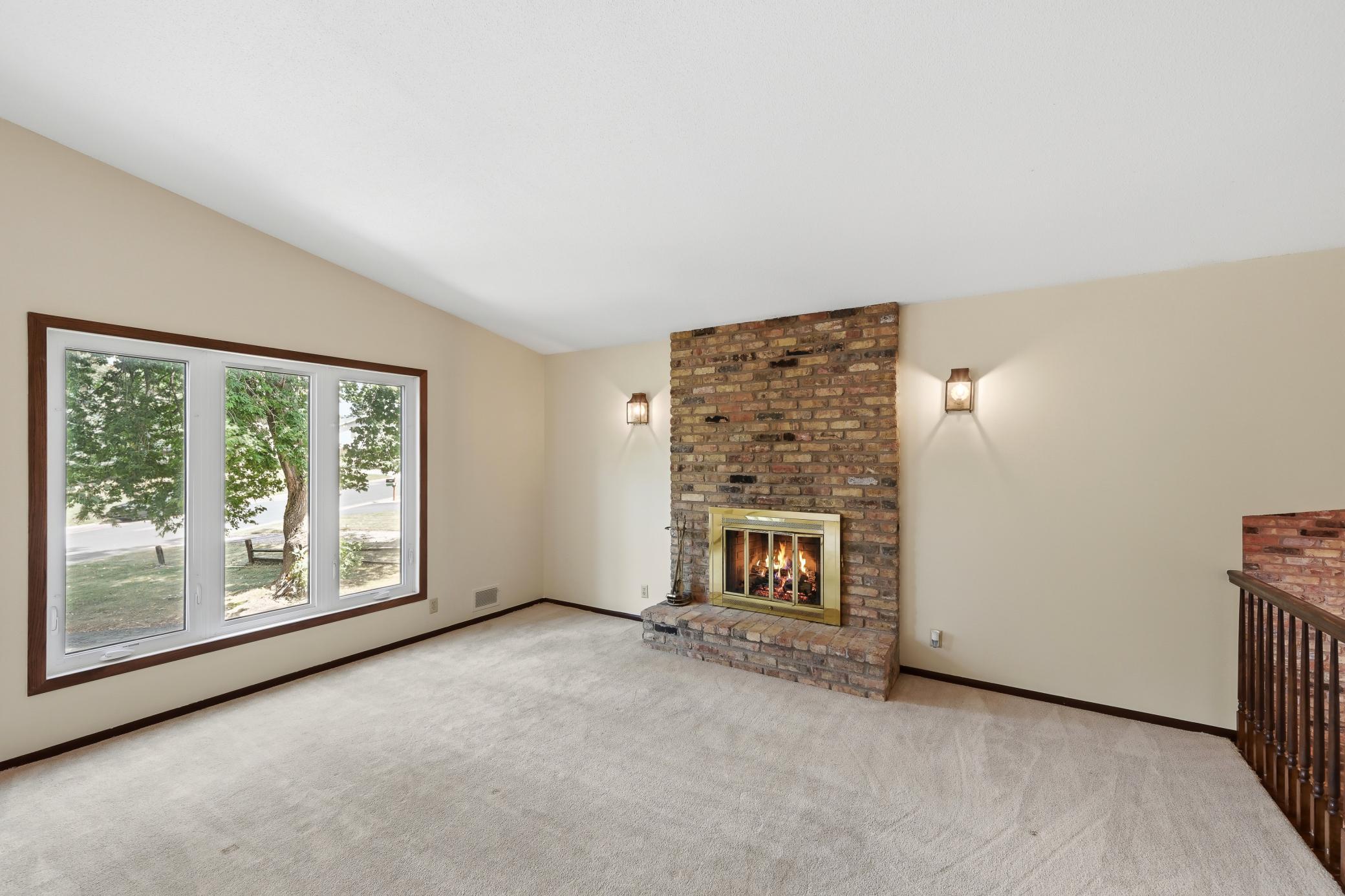 Living room with wood burning fireplace. Newer windows!