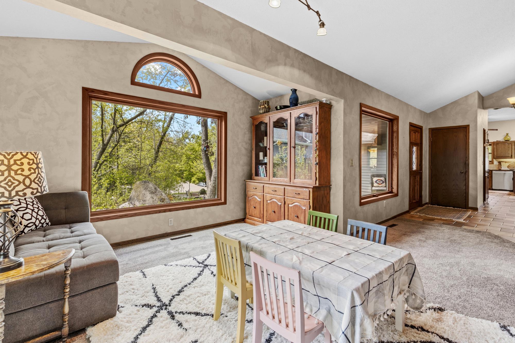 Living room has a large window that brings in lots of light.