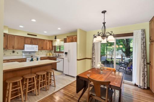 Dining Room and kitchen with sliding door leading out to maintenance free deck.
