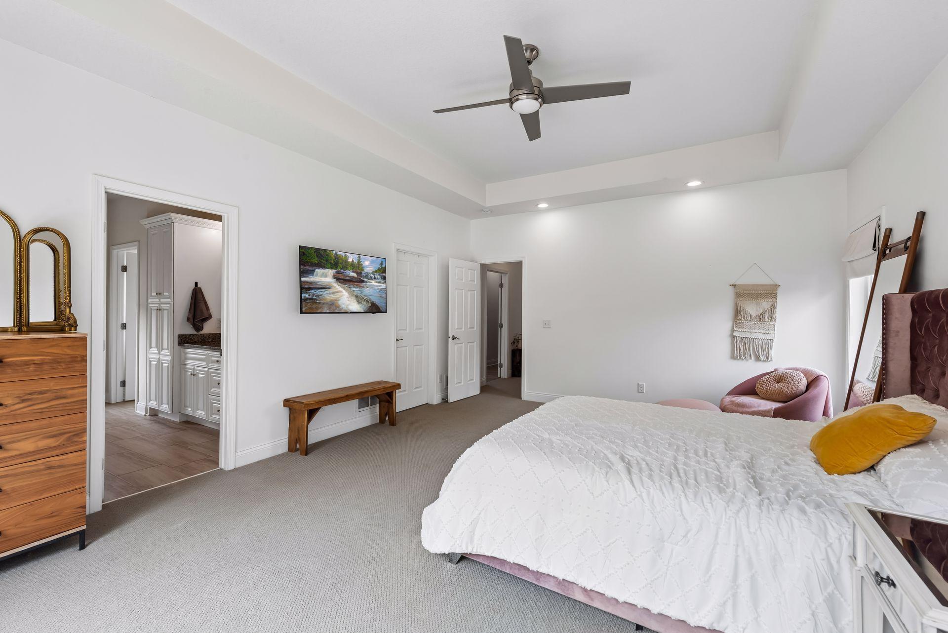 Wake up to beautiful treetop views from this expansive primary suite. The generous layout easily accommodates large furnishings while offering comfort, privacy, and abundant natural light.