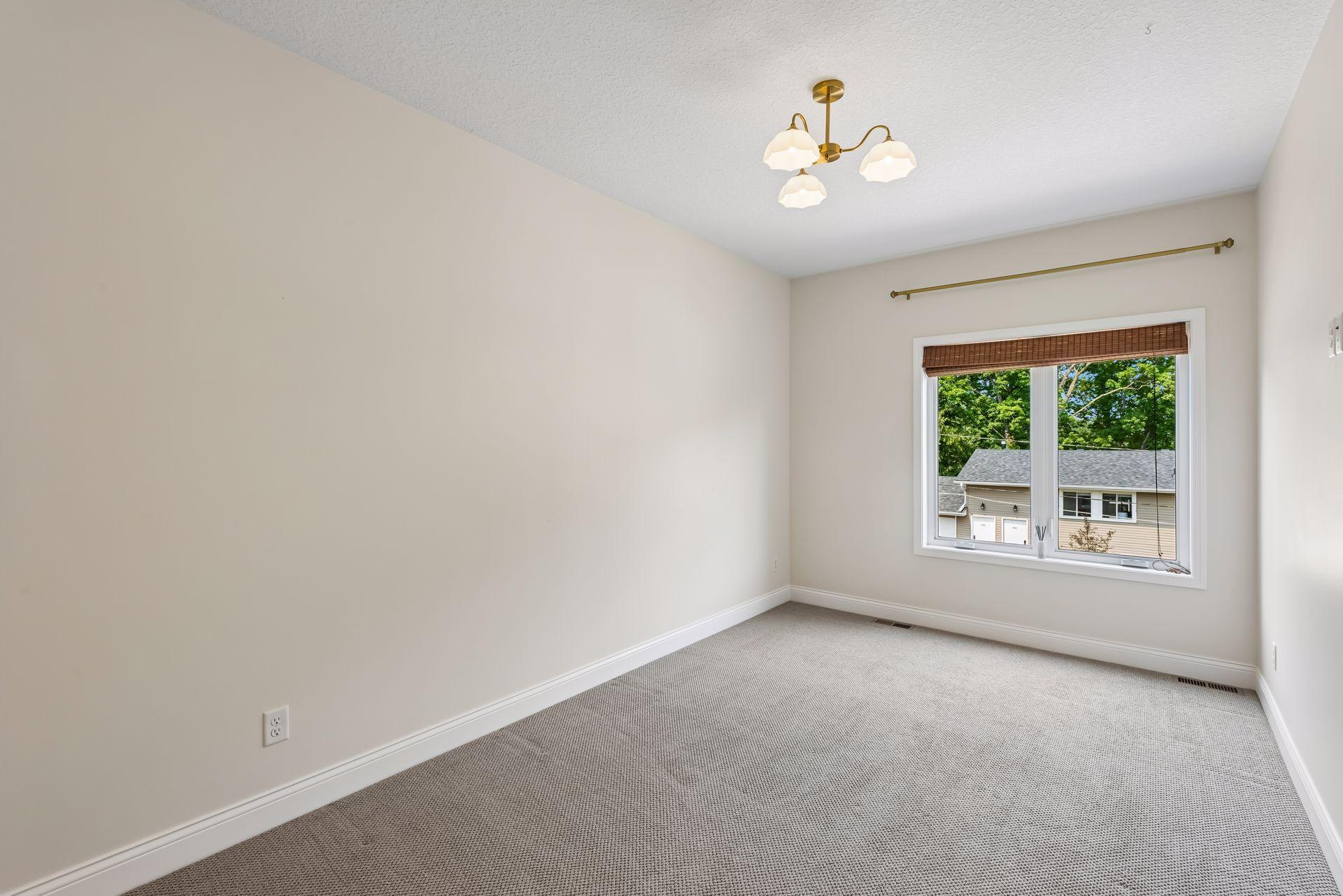 This generously sized bedroom offers flexibility for guests, family, or hobbies, complete with large windows, custom closets, and plenty of natural light throughout the day.
