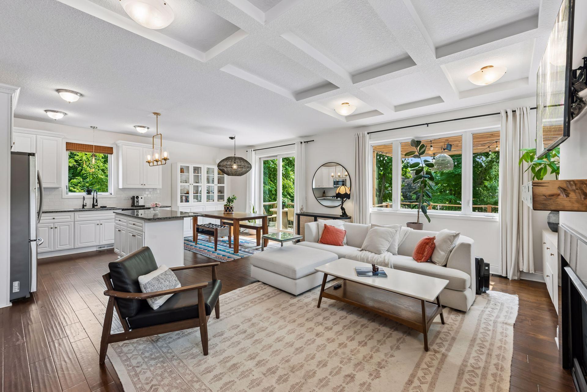 Designed for both comfort and style, this open living area seamlessly connects to the kitchen and dining spaces while showcasing elegant finishes and a beautiful gas fireplace.