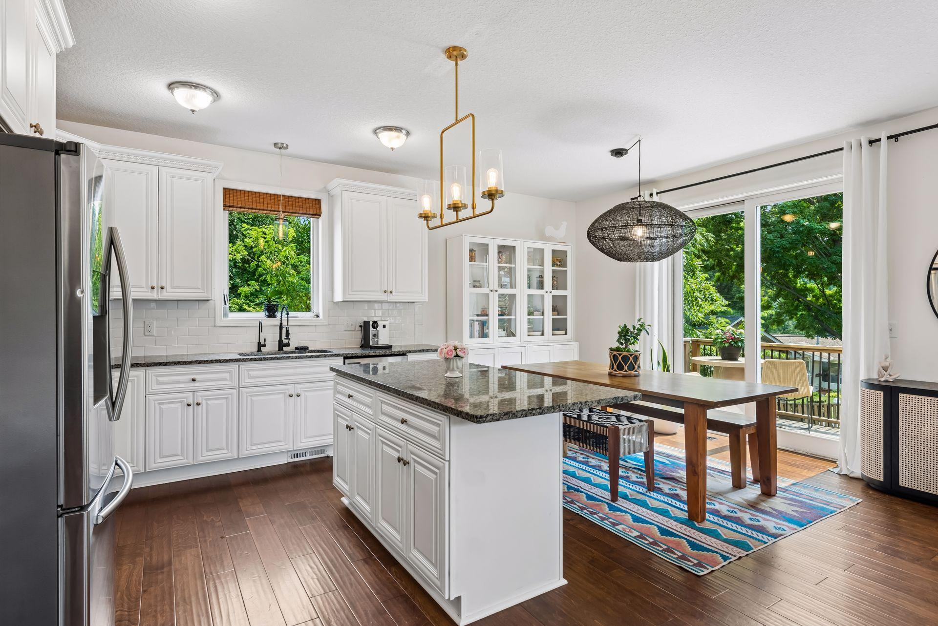 The open-concept kitchen and dining area are designed for everyday living and entertaining. Granite countertops, abundant cabinetry, and direct access to the expansive deck make hosting effortless.