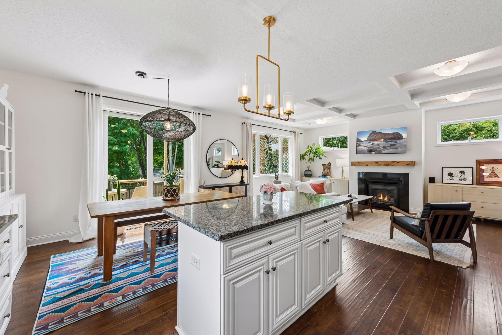 Gather with family and friends in this open-concept space where the oversized granite island overlooks the dining area and cozy living room, creating the perfect setting for entertaining year-round.