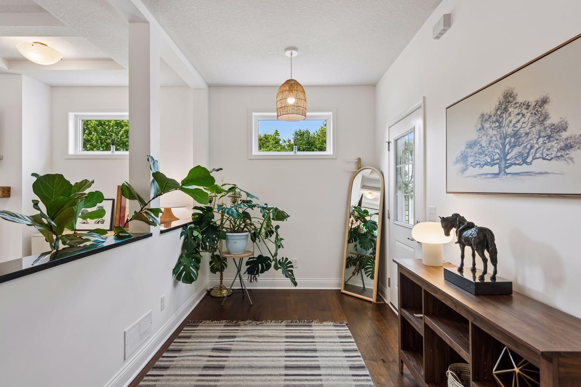 Step inside to a bright, welcoming foyer with rich hardwood floors and an open sightline to the heart of the home.