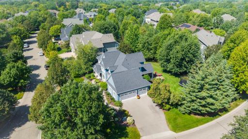 Aerial view of the corner lot. The neighborhood features curbs and sidewalks.