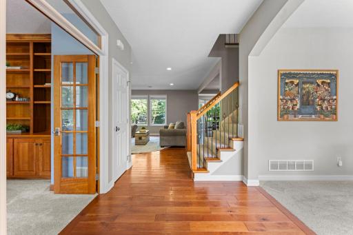 The foyer includes a convenient coat closet and opens up to the open layout living room, dining room and kitchen.