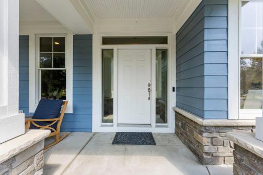 This home welcomes you with an adorable front porch and front door with side-lights and transom window.