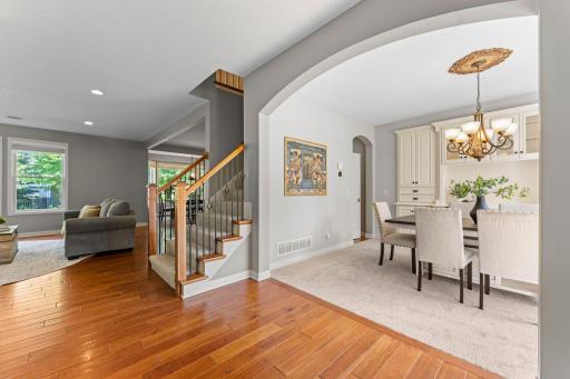 View of the formal dining room off the foyer with a decorative arched entry.