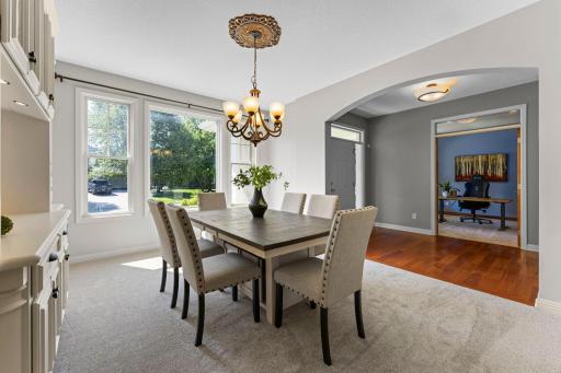 The formal dining room features brand-new carpet and a decorative chandelier.