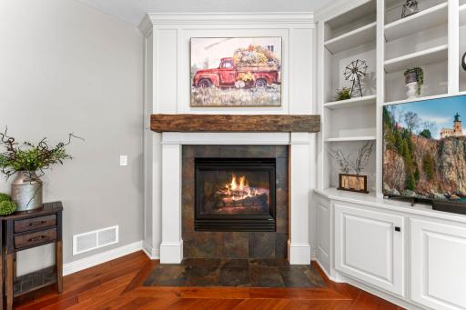 The gas fireplace is anchored by a beautiful reclaimed wood beam from a New York barn, complete with a built-in electrical outlet on top for easy lighting.