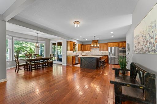 The informal dining room flows into the kitchen. It features beautiful cherry wood floors and plenty of space for a dining room set.