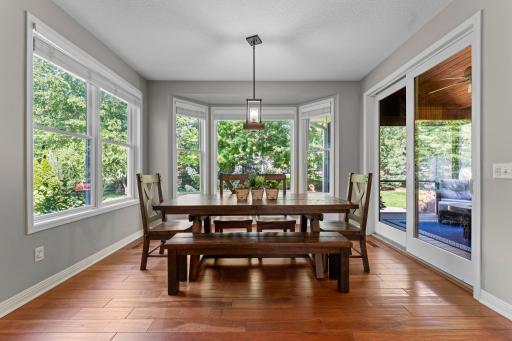 The breakfast nook area is surrounded by windows.