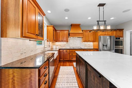 The kitchen has been remodeled and includes granite counters, tile backsplash, cherry cabinets, surround sound speakers, & pendant and recessed lights.