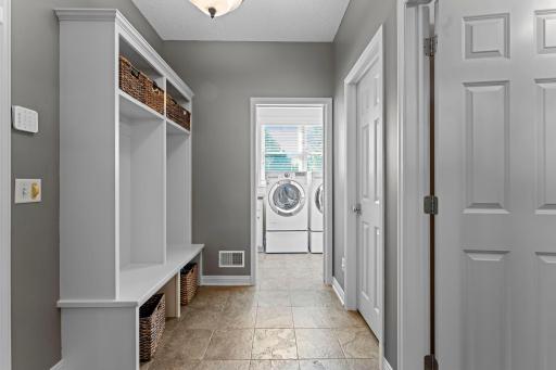 The mudroom includes ceramic tile floors and built-in lockers with cubbie storage.