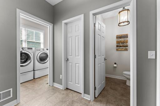 The mudroom provides access to the garage, walk-on pantry closet, powder room, and laundry room.