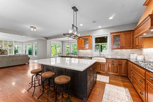View of the kitchen showing the open layout to the informal dining and living room.