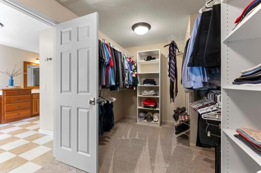 The private walk-in closet, with its organizational system, is perfect for all your storage needs.