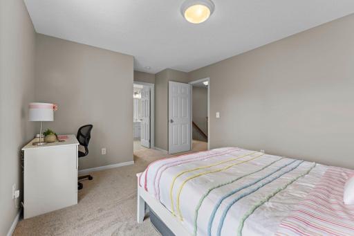 This view shows the flow of the third bedroom to the full Jack & Jill bathroom.