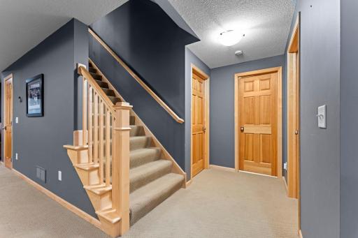 The finished lower level includes a large family entertainment room, the 5th bedroom, a 3/4 bathroom, and a mechanical room with additional storage.