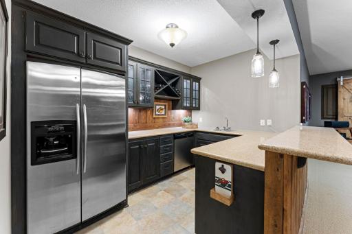 The bar also includes a dishwasher and sink. This bar is complete and ready for your parties.