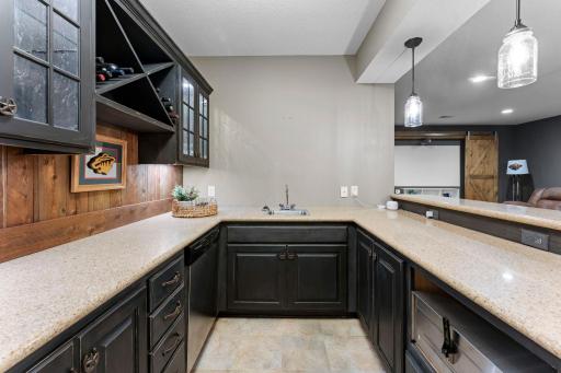 This bar has plenty of counter space and storage cabinets.