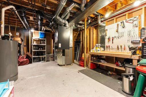 The mechanical room includes a Lennox furnace, an Aprilaire humidifier, a 50-gallon water heater (2021), an owned water softener, a Venmar whole-home air exchanger, and a drain tile and sump pump.