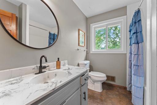 Bathroom has been remodeled and has a new tub and surround.