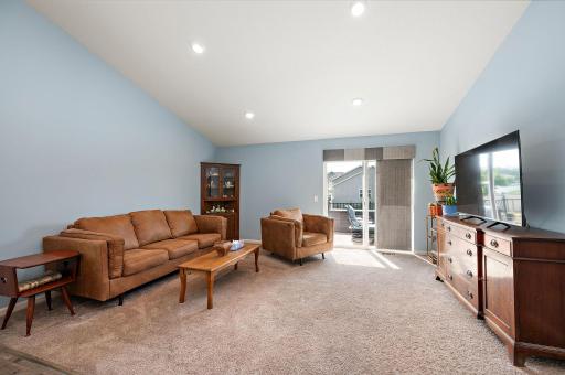 Main floor living room open to kitchen and walks out to deck.