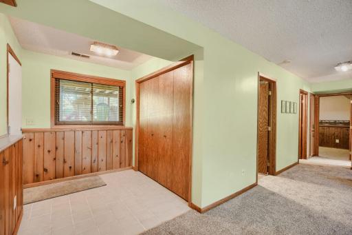 Garage entrance with storage closet connects with Family Room