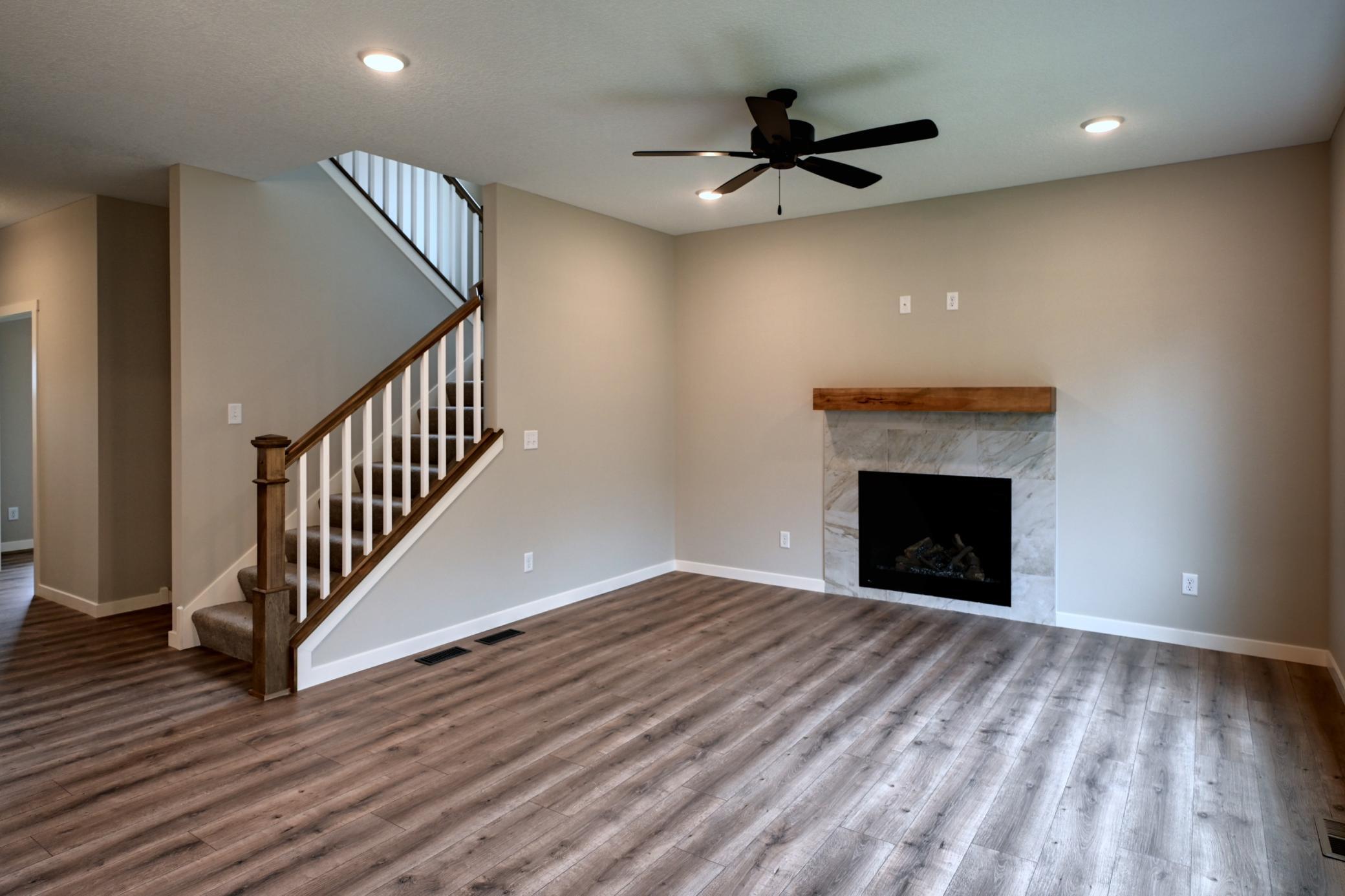 Living Room with Fireplace and Staircase