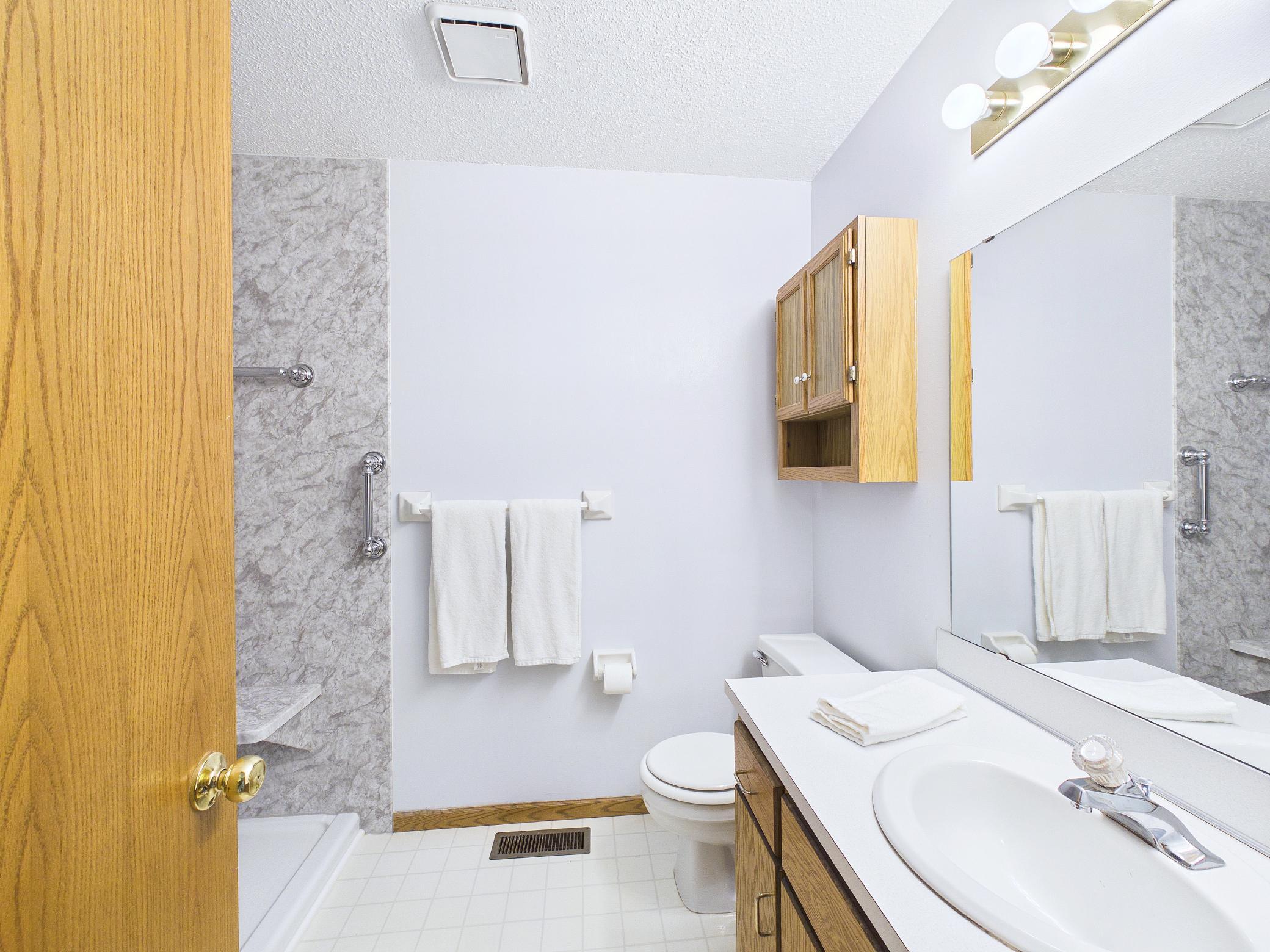 Recently remodeled bathroom features a spacious walk-in shower