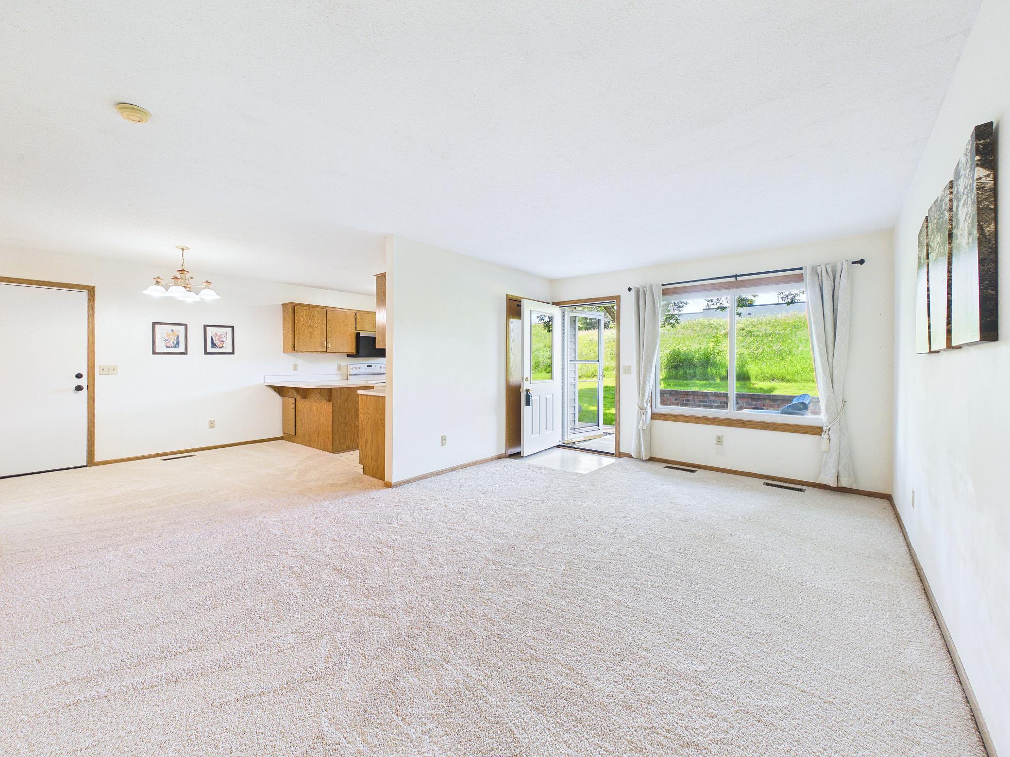 Sun-filled living spaces with brand new carpet and serene views.