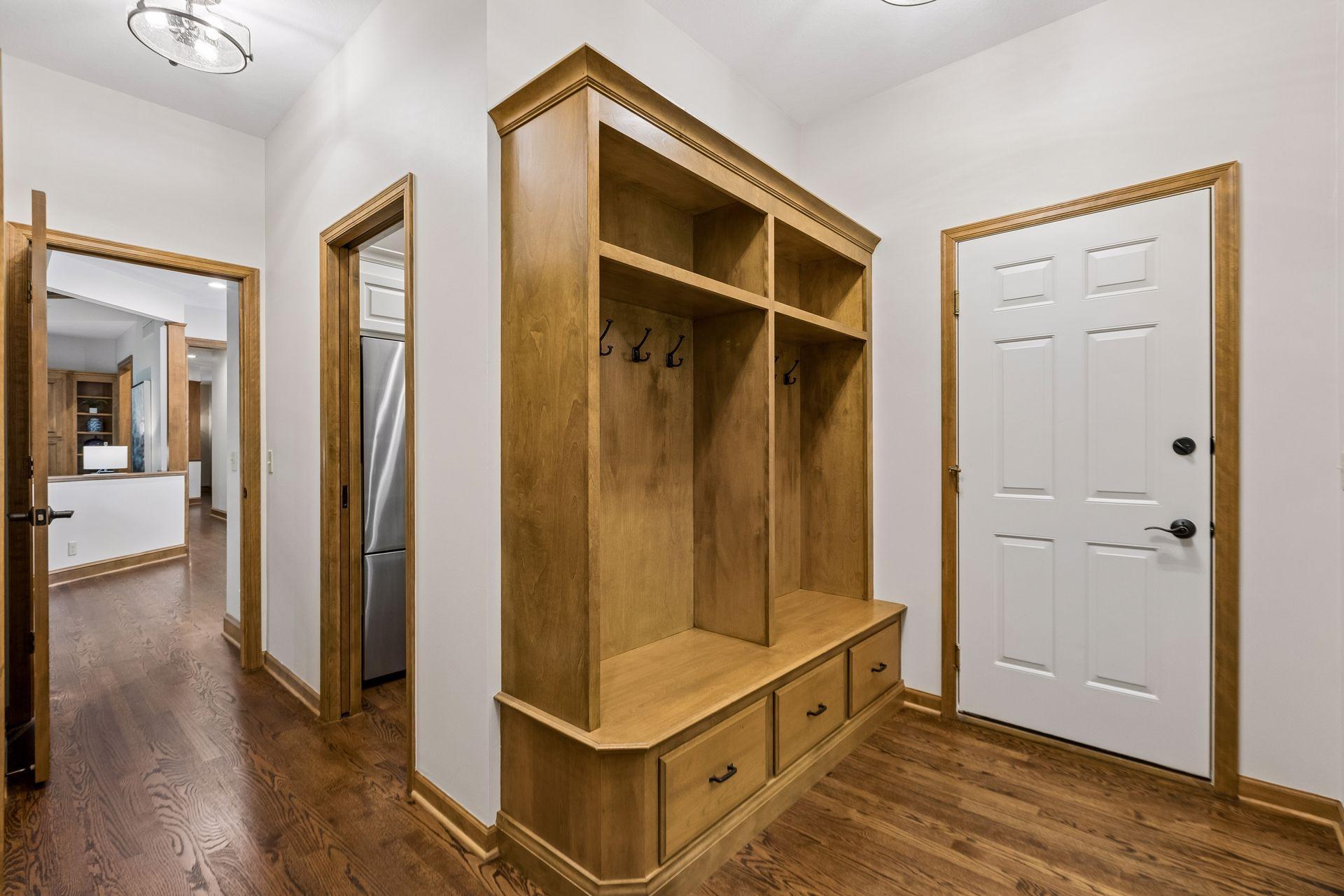 Mudroom includes ample storage and hooks, with a door leading straight to the garage.