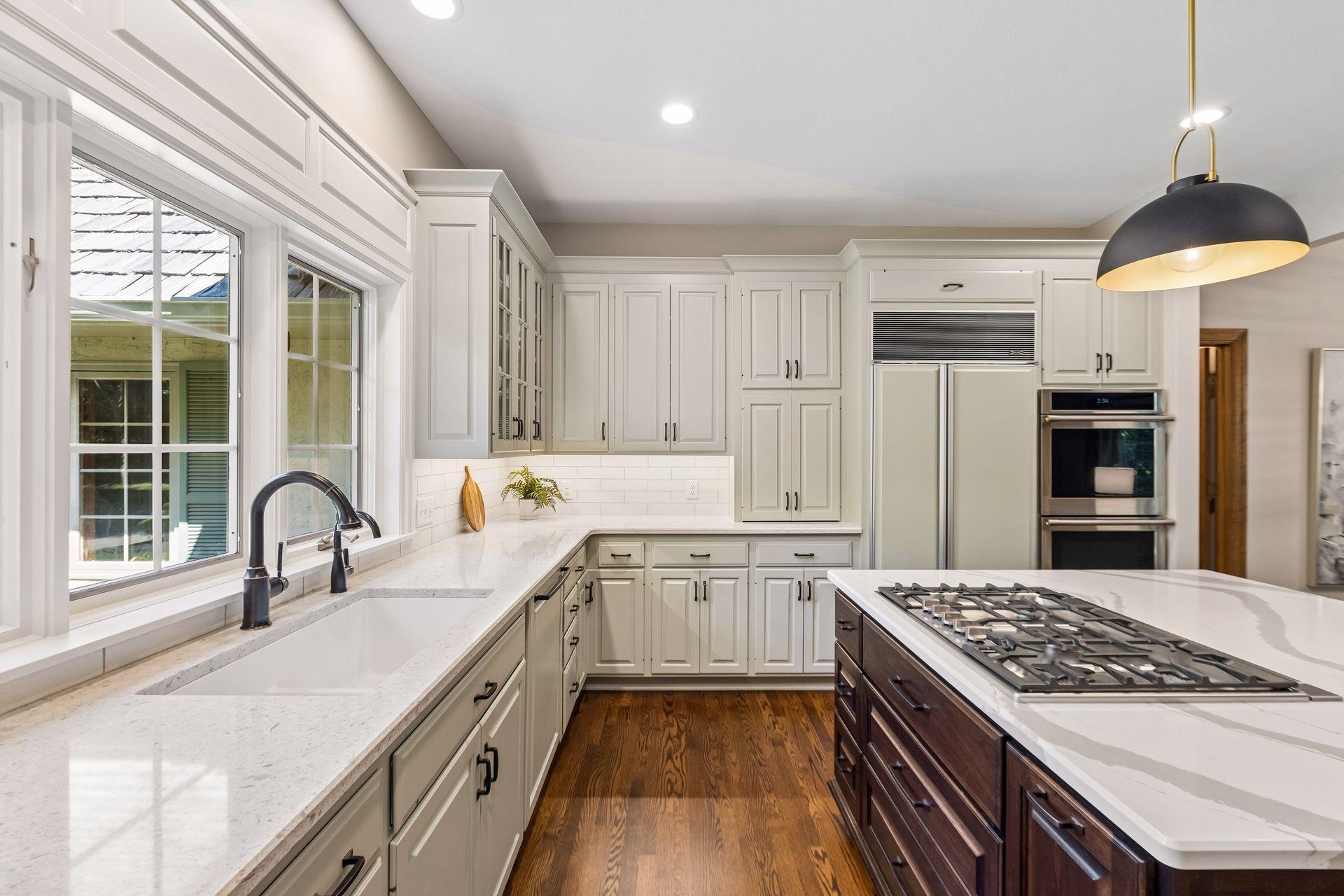 Kitchen features quartz countertops and a spacious center island with integrated stovetop.