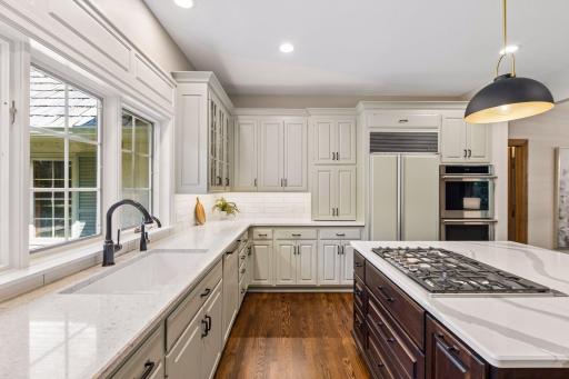 Kitchen features quartz countertops and a spacious center island with integrated stovetop.