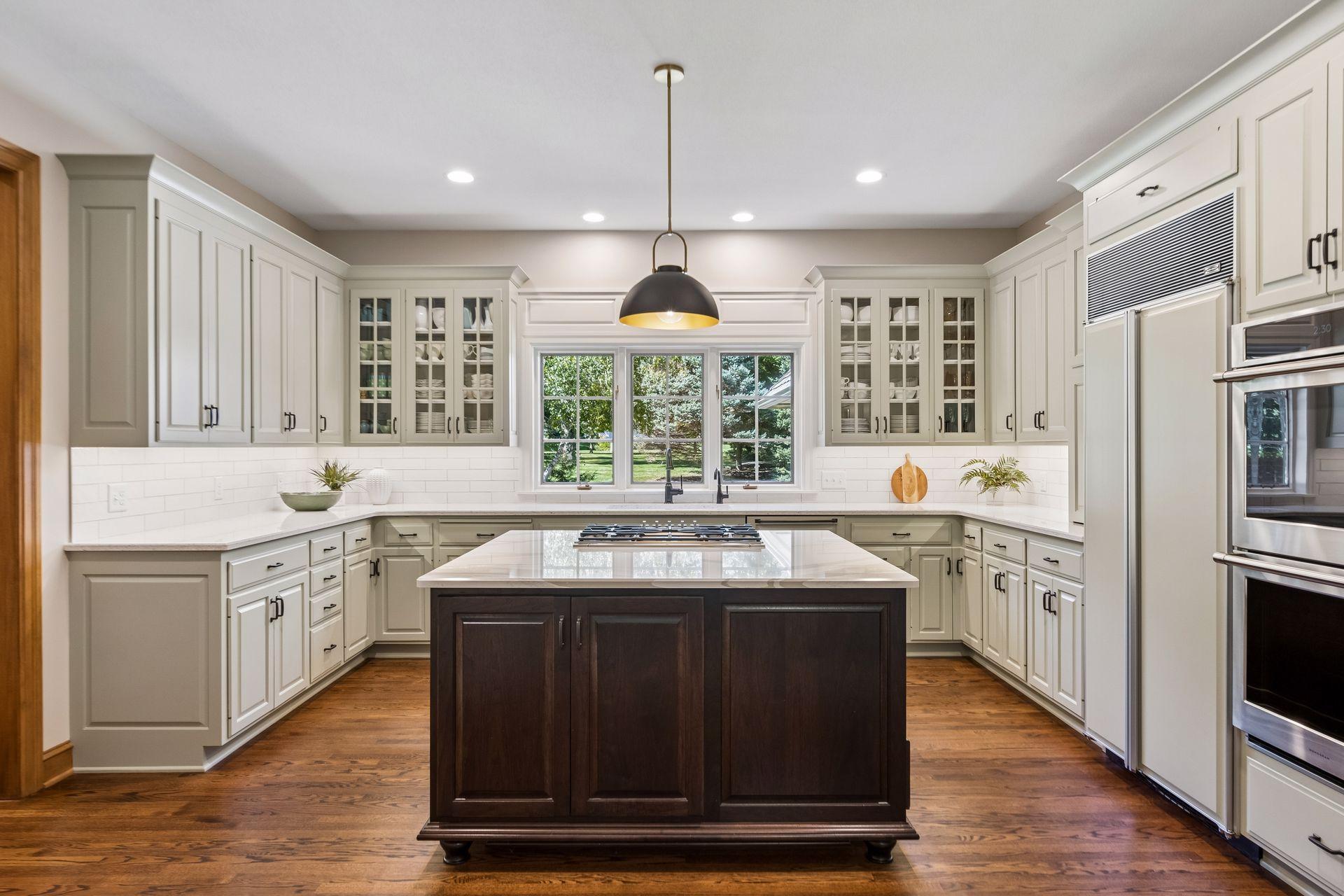 Kitchen features new appliances highlighted by a cabinet-flush refrigerator and double oven.