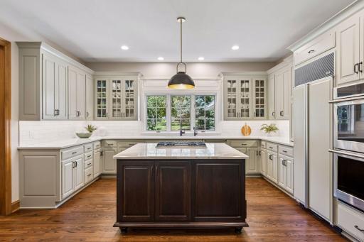 Kitchen features new appliances highlighted by a cabinet-flush refrigerator and double oven.