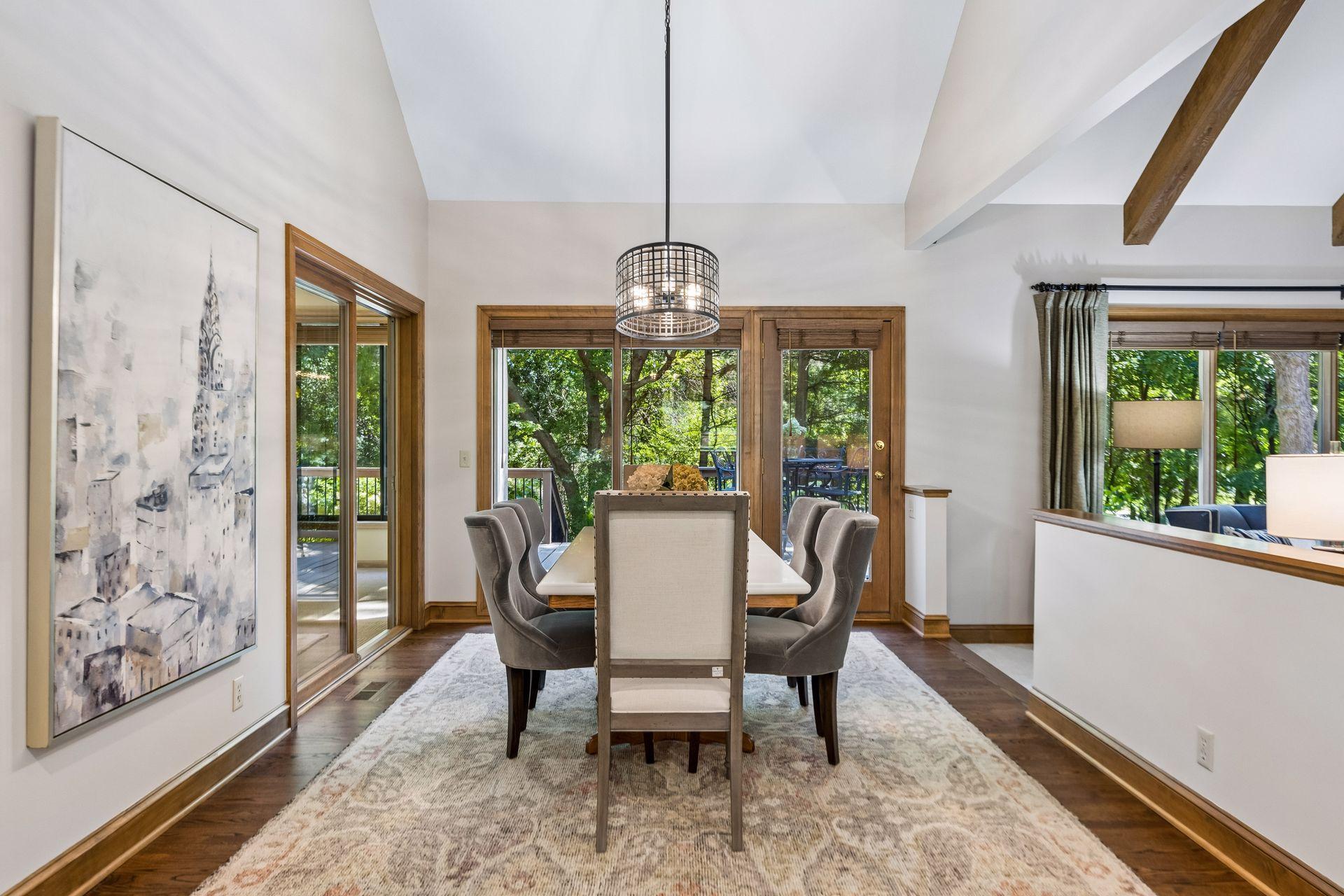 Informal dining room with doors leading to the 3-season porch and additional doors opening to the deck.