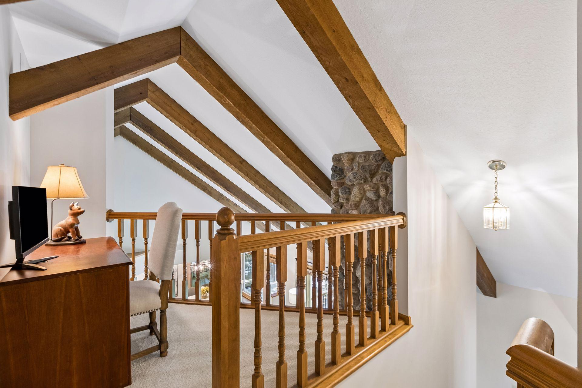 Loft at the top of the stairs overlooks the family room, creating an open and connected feel.
