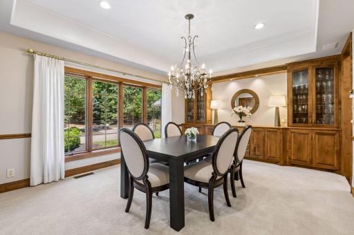 Large formal dining room sits just off the foyer and features custom built-ins.