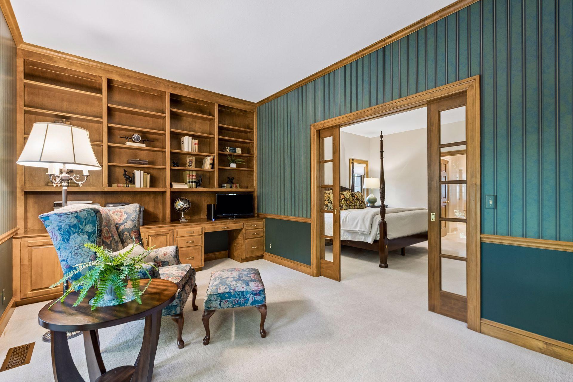 Connected office/sitting room off the primary bedroom with beautiful custom built-ins.